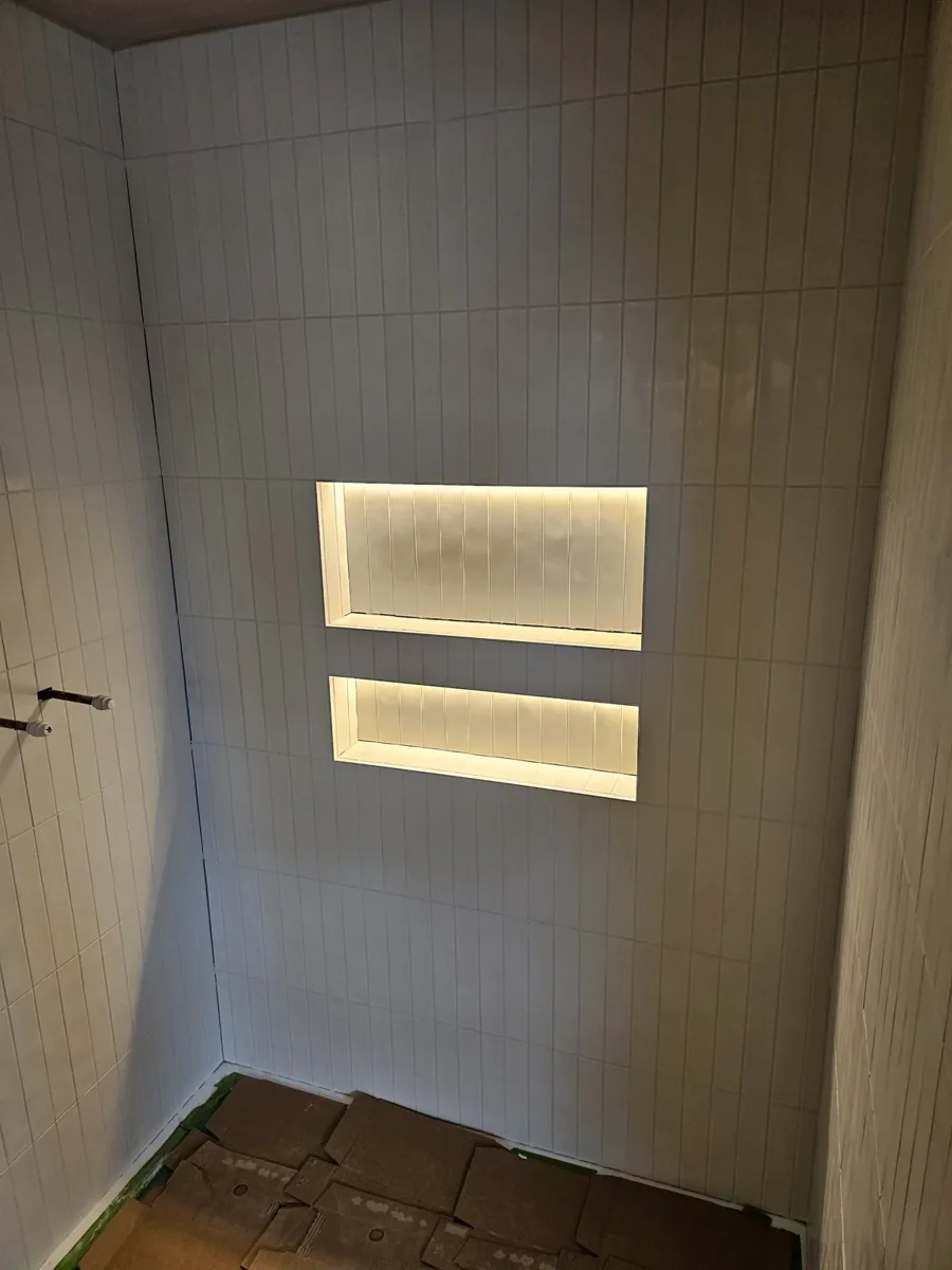 Warm lighting in recessed bathroom niches