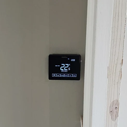 Close-up of the wall-mounted heating thermostat